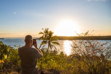 a man standing next to a body of water