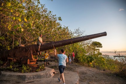 a man riding a bike down a dirt road