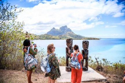 a group of people standing on a beach