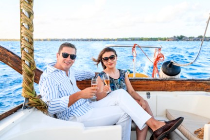 a group of people sitting in a boat on a body of water