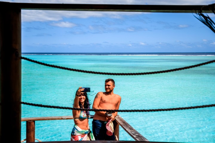 a man standing next to a body of water