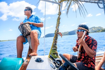 a group of people riding on the back of a boat