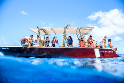 a group of people riding on the back of a boat